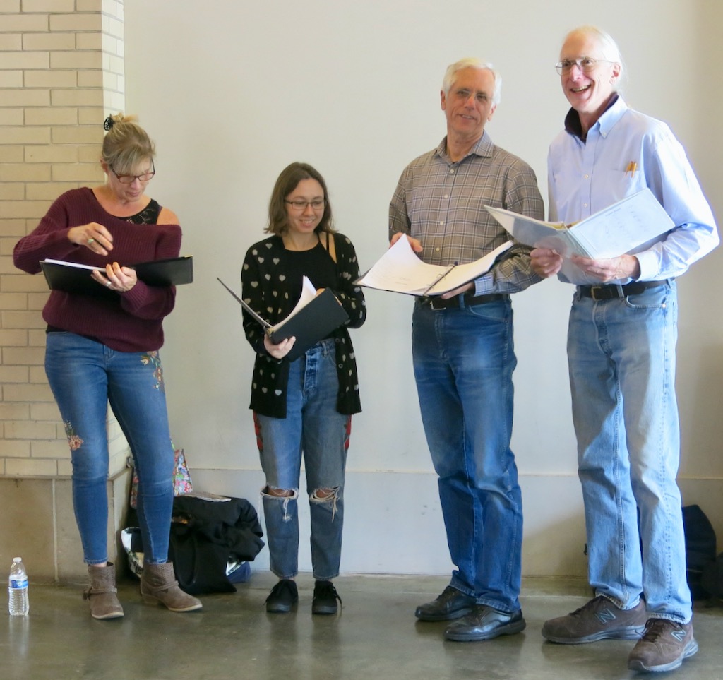 Four singers with music in a mall.